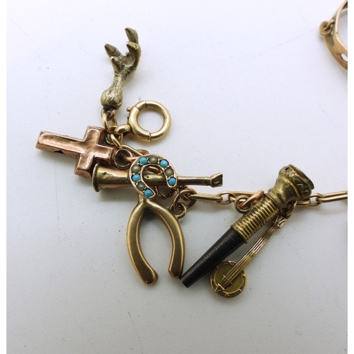 712 - A yellow metal charm bracelet, with twelve 9ct gold charms, seven yellow metal charms, to include a ... 