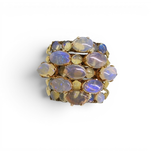 717 - A bright yellow metal five strand ring, each set with opals, size N1/2, weight 5.8gms