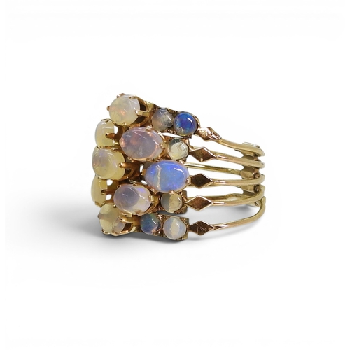 717 - A bright yellow metal five strand ring, each set with opals, size N1/2, weight 5.8gms