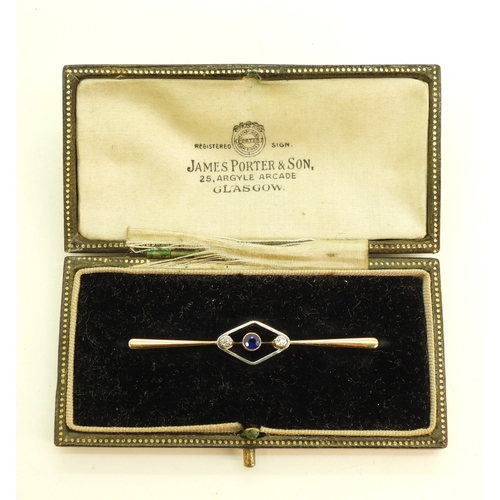 718 - A 15ct gold bar brooch set with a sapphire and diamonds, length 5.5cm, weight 4.6gms
