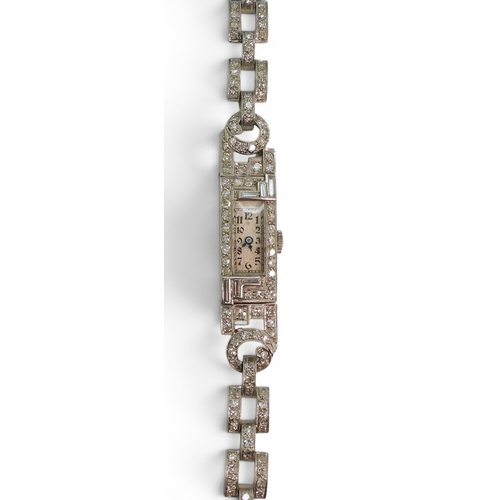 A platinum and diamond cocktail watch, set with baguette and eight cut diamonds in an Art Deco design, weight including mechanism 20.9gms