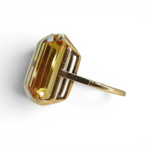 729 - A large citrine 23mm x 17mm, set into a yellow metal ring mount, size S, weight 11.2gms
