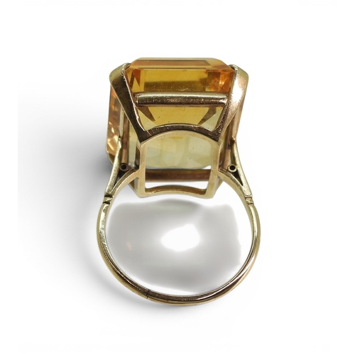 729 - A large citrine 23mm x 17mm, set into a yellow metal ring mount, size S, weight 11.2gms