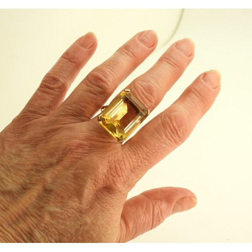 729 - A large citrine 23mm x 17mm, set into a yellow metal ring mount, size S, weight 11.2gms
