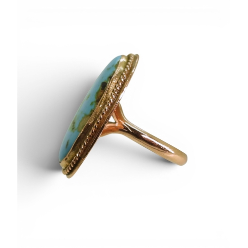 730 - A bright yellow metal turquoise set ring, size M, weight 9gms