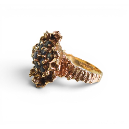 732 - A 9ct gold retro sapphire cluster ring, made by Slade & Woolf of Hatton Garden, London circa 196... 