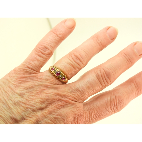 741 - A bright yellow metal ring set with synthetic rubies and diamond accents, (partial hallmark for Ches... 
