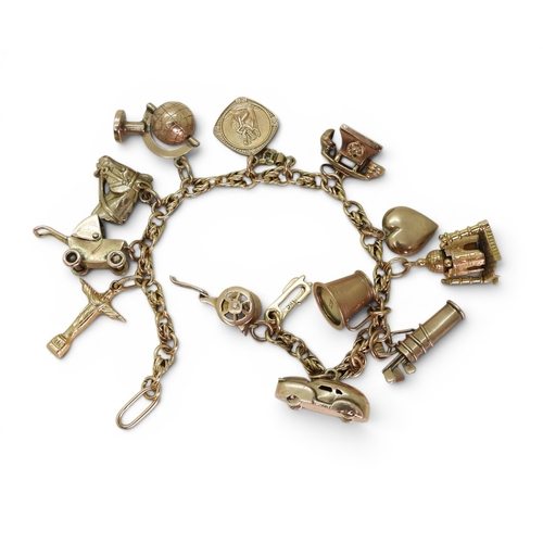 742 - An 18ct gold fancy link bracelet, with ten 9ct gold charms, one 18ct gold charm (Taj Mahal (af) and ... 