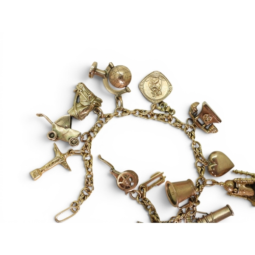 742 - An 18ct gold fancy link bracelet, with ten 9ct gold charms, one 18ct gold charm (Taj Mahal (af) and ... 