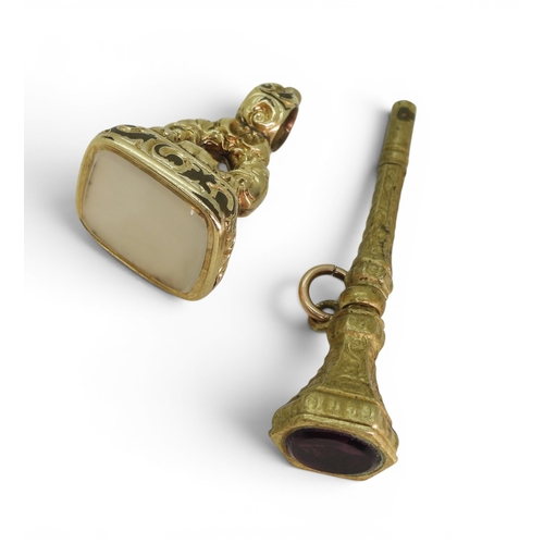 744 - A Georgian rolled gold white agate fob seal, together with a gem set watch key.