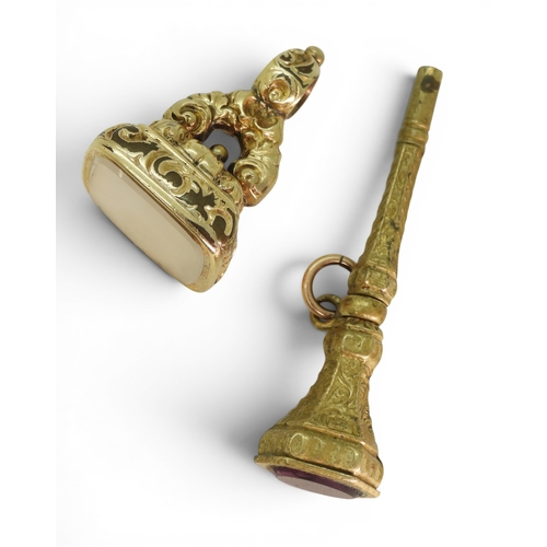 744 - A Georgian rolled gold white agate fob seal, together with a gem set watch key.