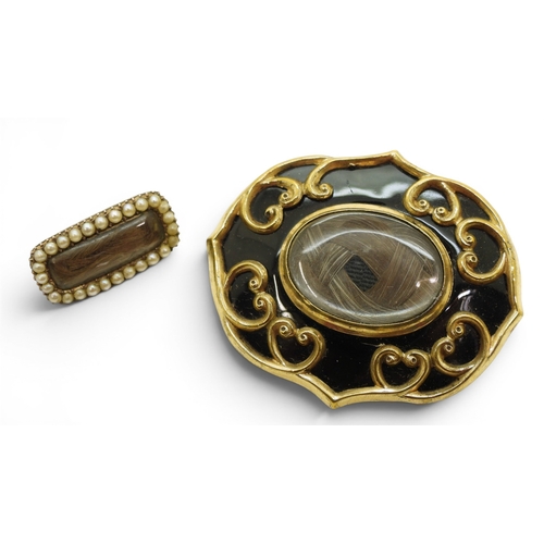 747 - Two Victorian mourning brooches with hair art panels the smaller also set with pearls, gold plated m... 