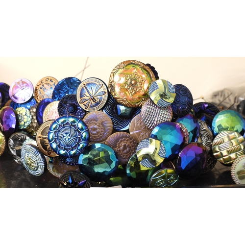 880 - A large collection of irridescent carnival glass hat pins, in various themes and colour ways, most w... 
