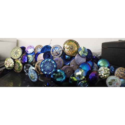 880 - A large collection of irridescent carnival glass hat pins, in various themes and colour ways, most w... 