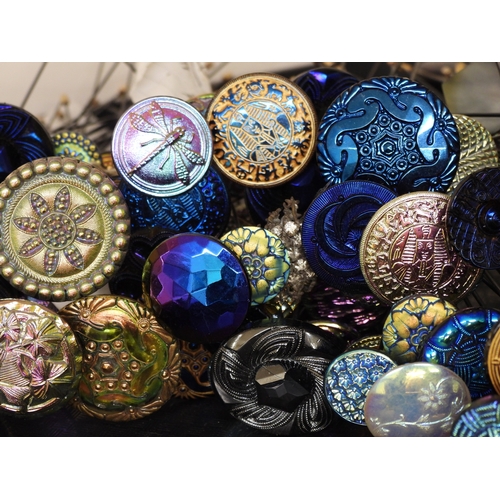 880 - A large collection of irridescent carnival glass hat pins, in various themes and colour ways, most w... 