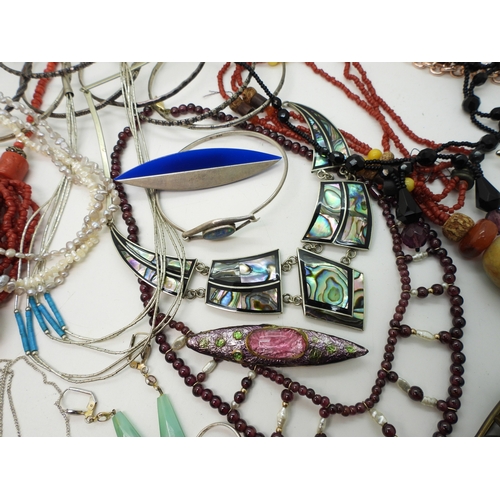 886 - Silver bangles to include one set with an opal triplet, a garnet and faux pearl collar, a liquid sil... 
