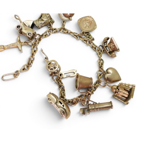 742 - An 18ct gold fancy link bracelet, with ten 9ct gold charms, one 18ct gold charm (Taj Mahal (af) and ... 