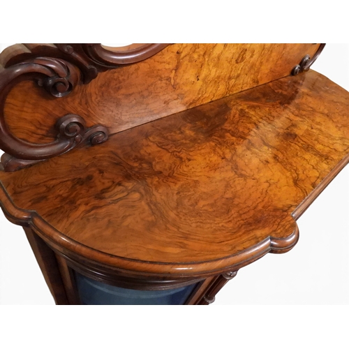 2040 - A VICTORIAN WALNUT VENEERED CREDENZAwith carved scrolled backsplash over central glazed doors flanke... 