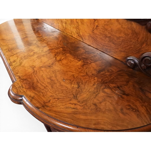 2040 - A VICTORIAN WALNUT VENEERED CREDENZAwith carved scrolled backsplash over central glazed doors flanke... 