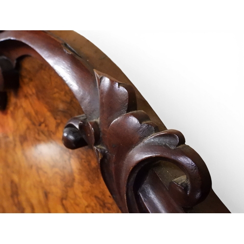 2040 - A VICTORIAN WALNUT VENEERED CREDENZAwith carved scrolled backsplash over central glazed doors flanke... 