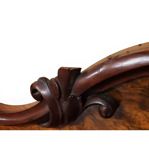 2040 - A VICTORIAN WALNUT VENEERED CREDENZAwith carved scrolled backsplash over central glazed doors flanke... 