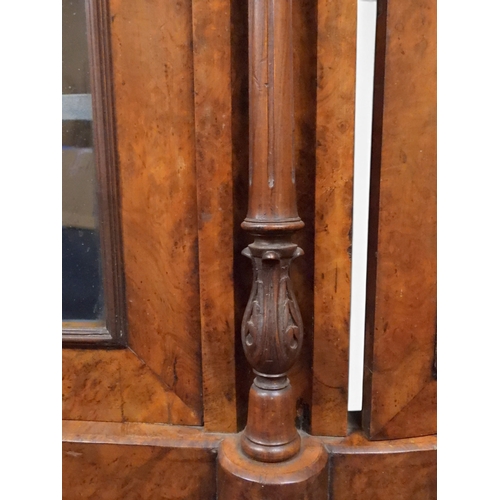 2040 - A VICTORIAN WALNUT VENEERED CREDENZAwith carved scrolled backsplash over central glazed doors flanke... 