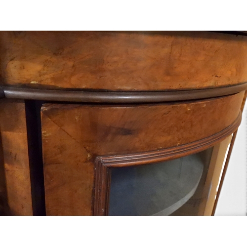 2040 - A VICTORIAN WALNUT VENEERED CREDENZAwith carved scrolled backsplash over central glazed doors flanke... 