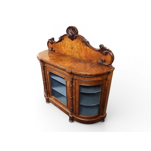 2040 - A VICTORIAN WALNUT VENEERED CREDENZAwith carved scrolled backsplash over central glazed doors flanke... 