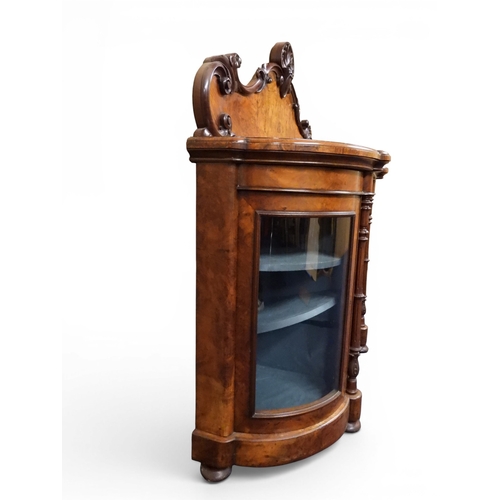 2040 - A VICTORIAN WALNUT VENEERED CREDENZAwith carved scrolled backsplash over central glazed doors flanke... 