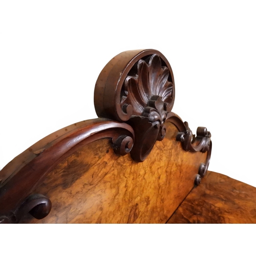 2040 - A VICTORIAN WALNUT VENEERED CREDENZAwith carved scrolled backsplash over central glazed doors flanke... 