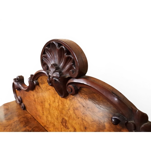 2040 - A VICTORIAN WALNUT VENEERED CREDENZAwith carved scrolled backsplash over central glazed doors flanke... 