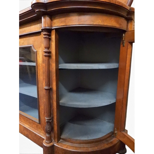 2040 - A VICTORIAN WALNUT VENEERED CREDENZAwith carved scrolled backsplash over central glazed doors flanke... 