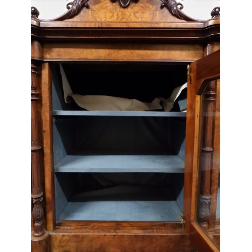 2040 - A VICTORIAN WALNUT VENEERED CREDENZAwith carved scrolled backsplash over central glazed doors flanke... 