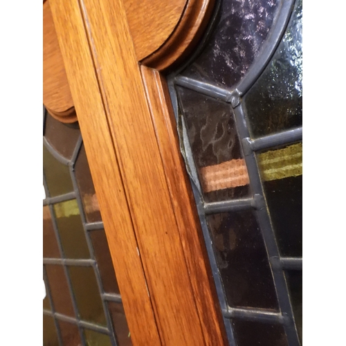 2042 - AN EARLY 20TH CENTURY OAK FOUR DOOR BOOKCASE&nbsp;with plain top over four leaded stained glass door... 