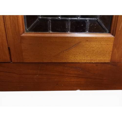 2042 - AN EARLY 20TH CENTURY OAK FOUR DOOR BOOKCASE&nbsp;with plain top over four leaded stained glass door... 