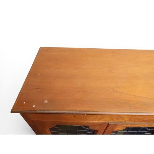 2042 - AN EARLY 20TH CENTURY OAK FOUR DOOR BOOKCASE&nbsp;with plain top over four leaded stained glass door... 