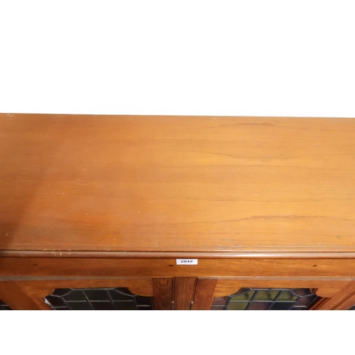 2042 - AN EARLY 20TH CENTURY OAK FOUR DOOR BOOKCASE&nbsp;with plain top over four leaded stained glass door... 