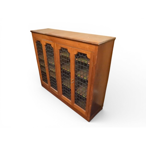 2042 - AN EARLY 20TH CENTURY OAK FOUR DOOR BOOKCASE&nbsp;with plain top over four leaded stained glass door... 