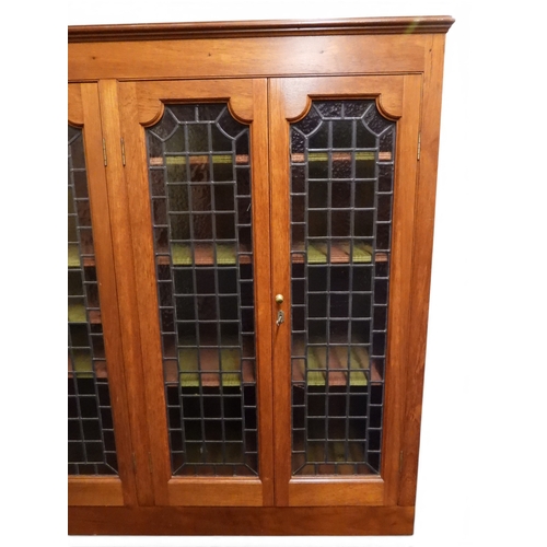 2042 - AN EARLY 20TH CENTURY OAK FOUR DOOR BOOKCASE&nbsp;with plain top over four leaded stained glass door... 