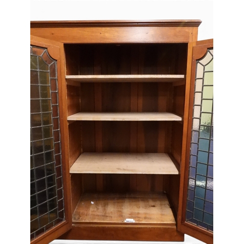 2042 - AN EARLY 20TH CENTURY OAK FOUR DOOR BOOKCASE&nbsp;with plain top over four leaded stained glass door... 