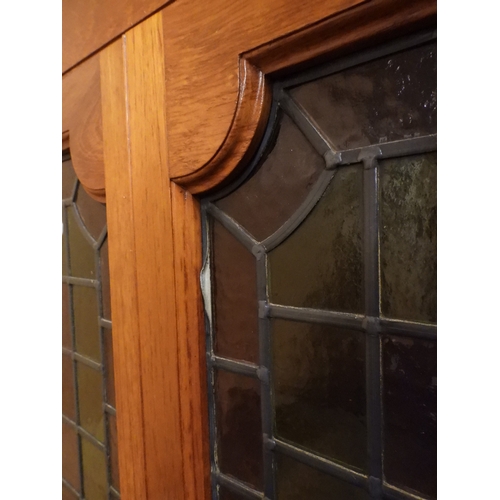 2042 - AN EARLY 20TH CENTURY OAK FOUR DOOR BOOKCASE&nbsp;with plain top over four leaded stained glass door... 