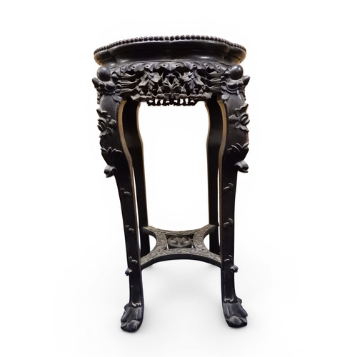 2050 - A 19TH CENTURY CHINESE HARDWOOD JARDINIERE STAND&nbsp;shaped marble inset top over carved pierced fr... 
