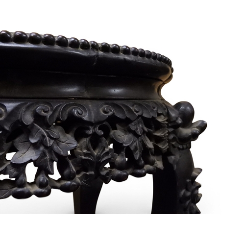 2050 - A 19TH CENTURY CHINESE HARDWOOD JARDINIERE STAND&nbsp;shaped marble inset top over carved pierced fr... 