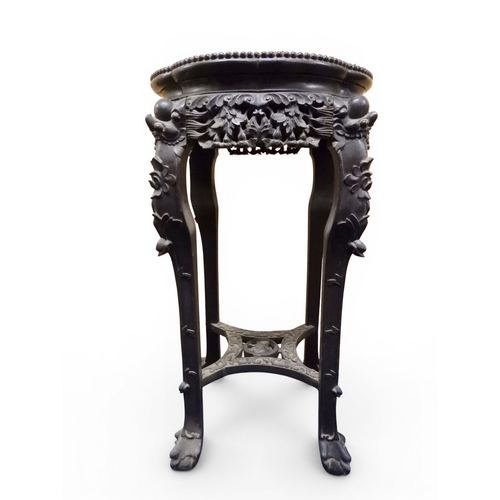 2050 - A 19TH CENTURY CHINESE HARDWOOD JARDINIERE STAND&nbsp;shaped marble inset top over carved pierced fr... 