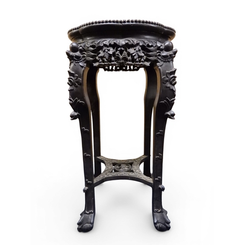 2050 - A 19TH CENTURY CHINESE HARDWOOD JARDINIERE STAND&nbsp;shaped marble inset top over carved pierced fr... 