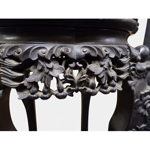 2050 - A 19TH CENTURY CHINESE HARDWOOD JARDINIERE STAND&nbsp;shaped marble inset top over carved pierced fr... 