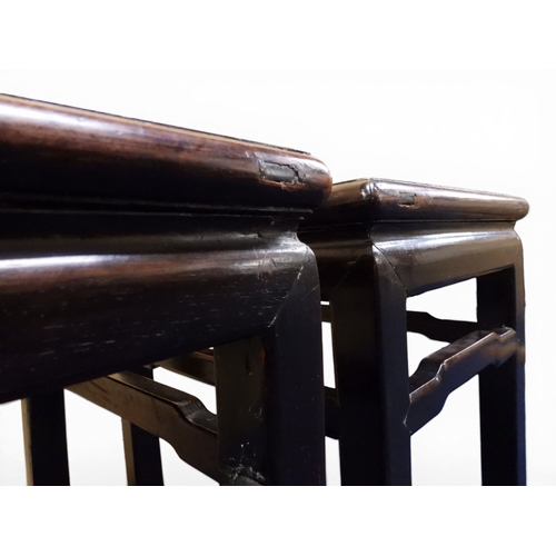 2052 - A PAIR OF 19TH CENTURY CHINESE HARDWOOD LOW TABLES with plain rectangular tops on square shaped supp... 