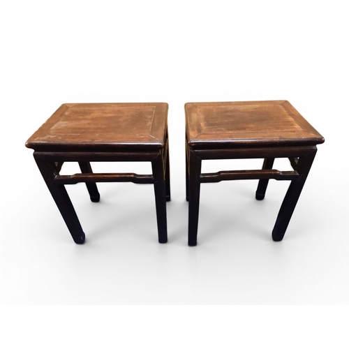 2052 - A PAIR OF 19TH CENTURY CHINESE HARDWOOD LOW TABLES with plain rectangular tops on square shaped supp... 