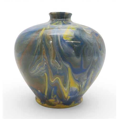 53A - A marbled slipware vase of squat baluster form with small flared lip, in hues of blue and brown over...
