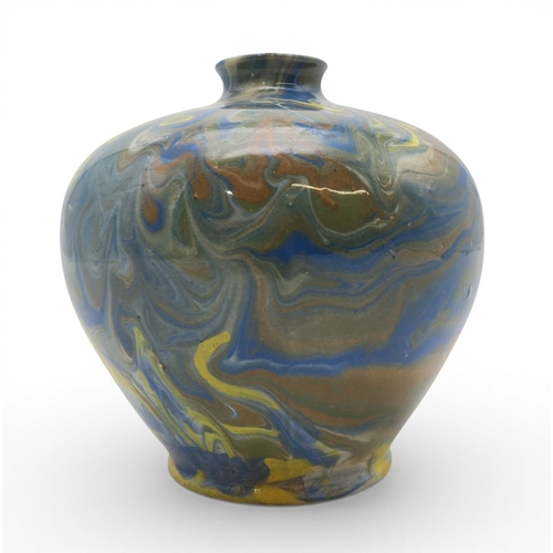 53A - A marbled slipware vase of squat baluster form with small flared lip, in hues of blue and brown over...